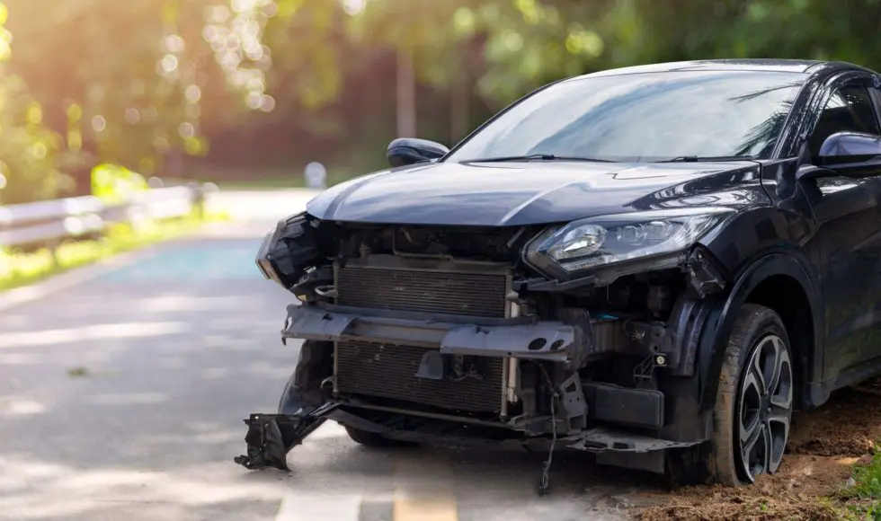 Front of black color car big damaged and broken by accident on city street parking can not drive any more. With copy space for text or design