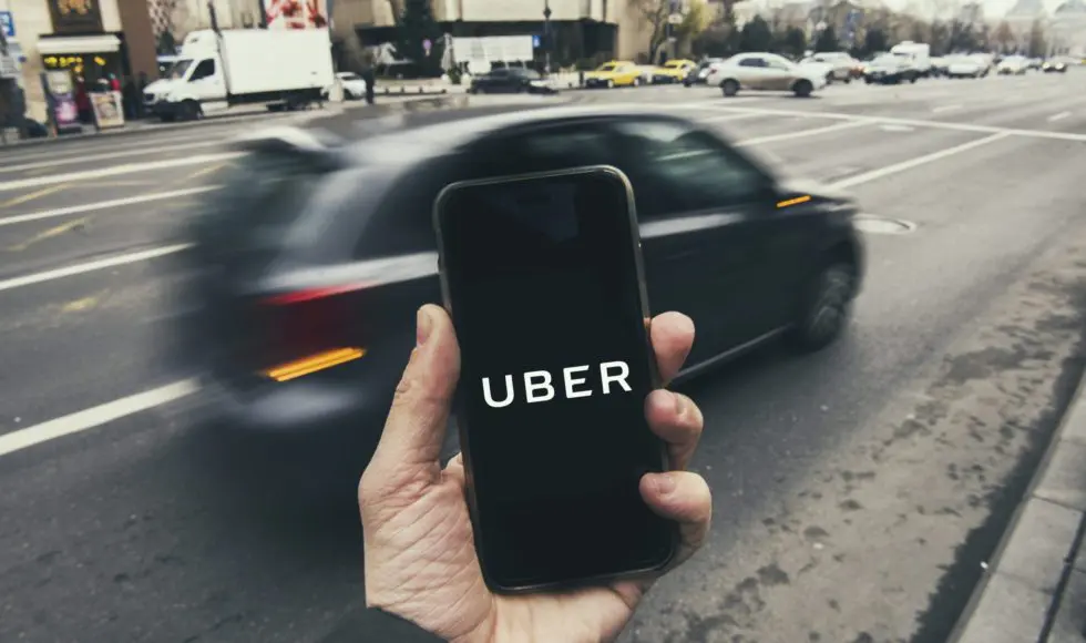 Bucharest, Romania - December 22: Man holding a smart phone with Uber app.