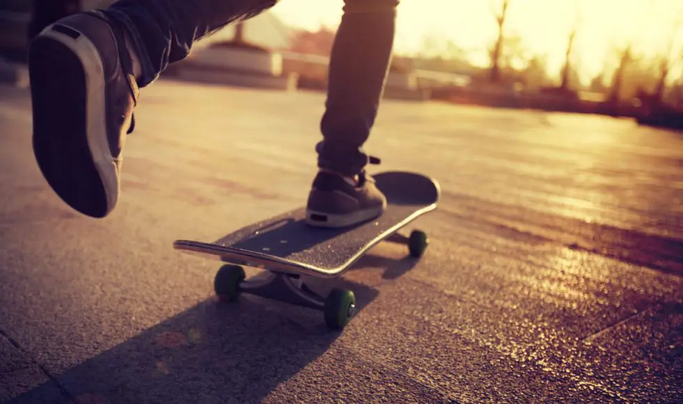 Skateboarder skateboarding at sunrise city